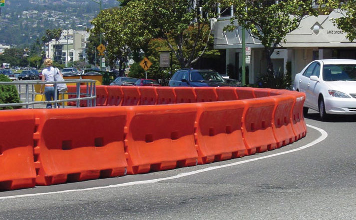 orange waterfilled barrier on a road